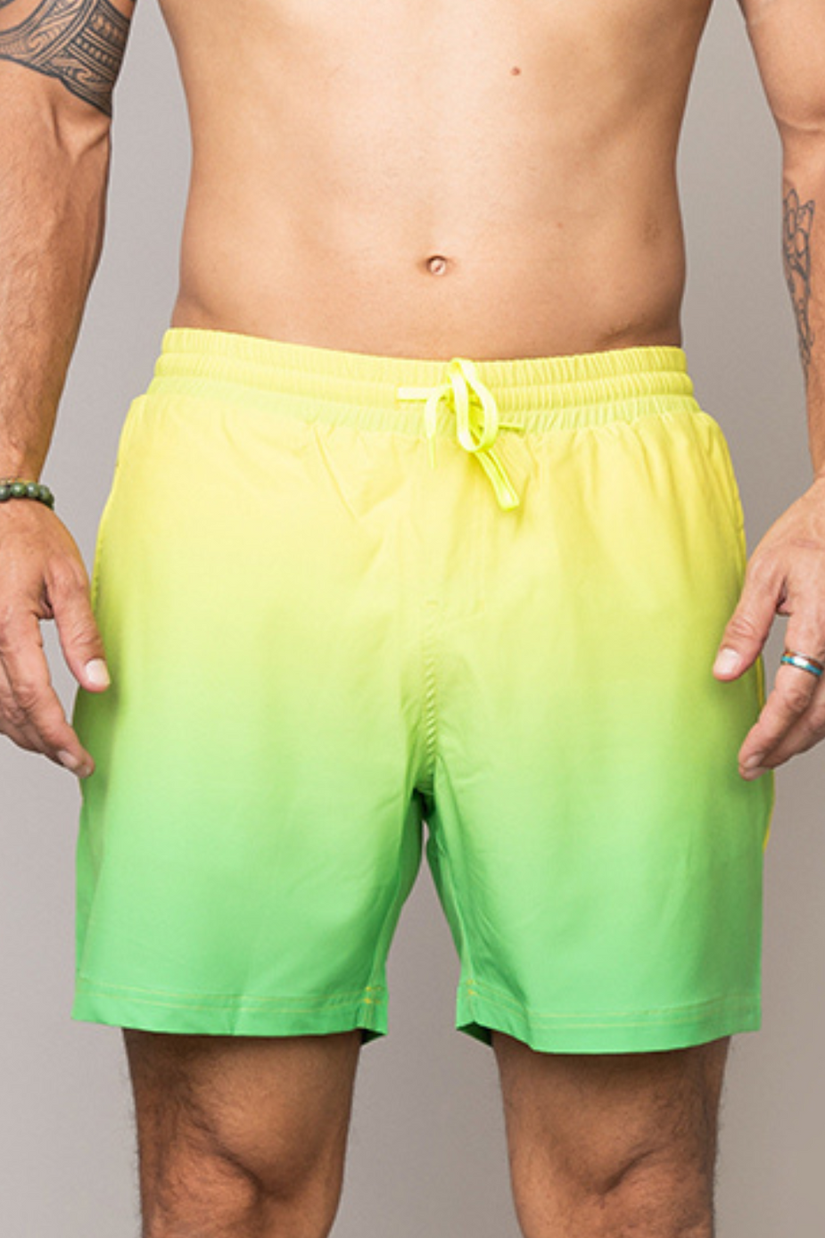 a man wearing shorts with a green and yellow gradient